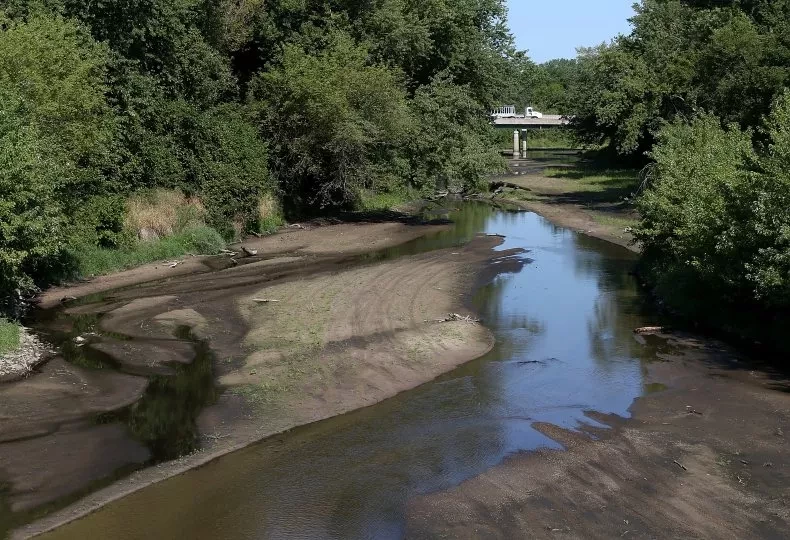 A river with low levels of water flows under Highway 65 near Bondurant, Iowa. Iowa is suffering through a prolonged drought that heightens concerns about the water use by the state's data centers.